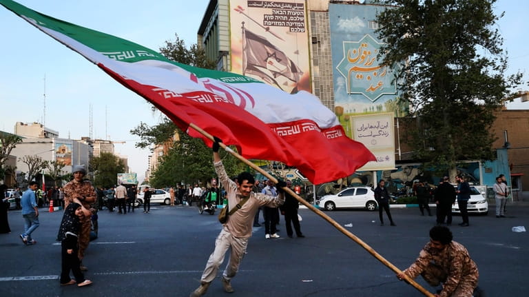 Demonstrators wave a huge Iranian flag in their anti-Israeli gathering...