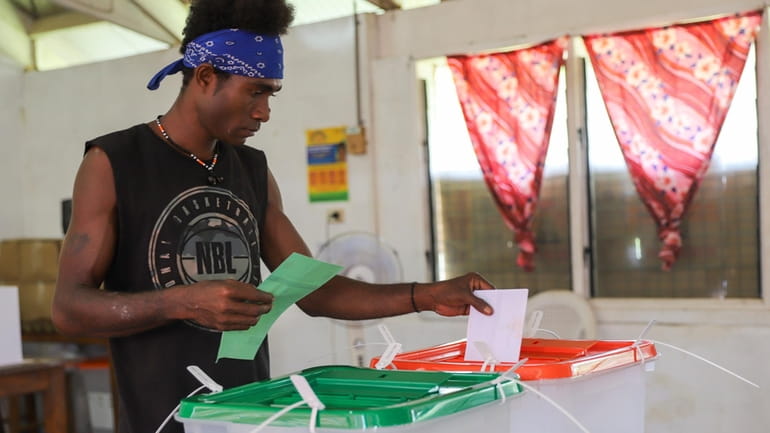 A man casts his vote during the Solomon Islands elections...