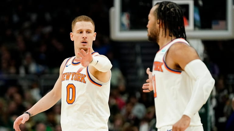 The Knicks' Donte DiVincenzo celebrates with Jalen Brunson, right, during the...