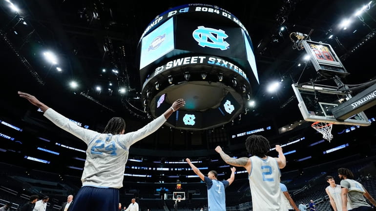 North Carolina players warm up during practice ahead of their...
