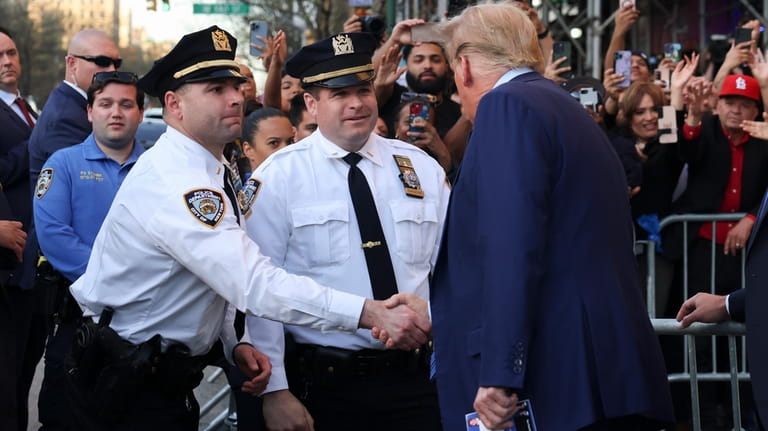 Former president Donald Trump, talks to New York Police officers...