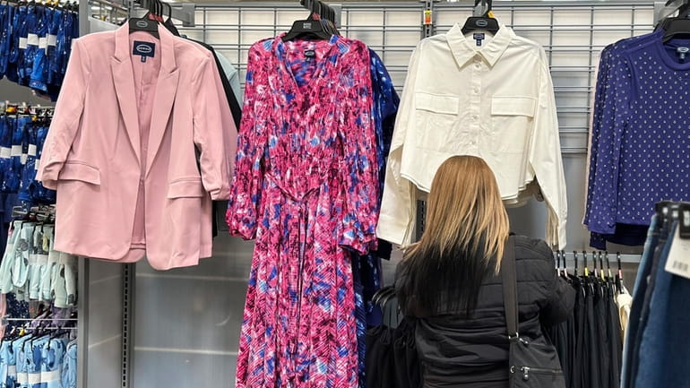 A shopper looks at clothes at a Walmart store in...