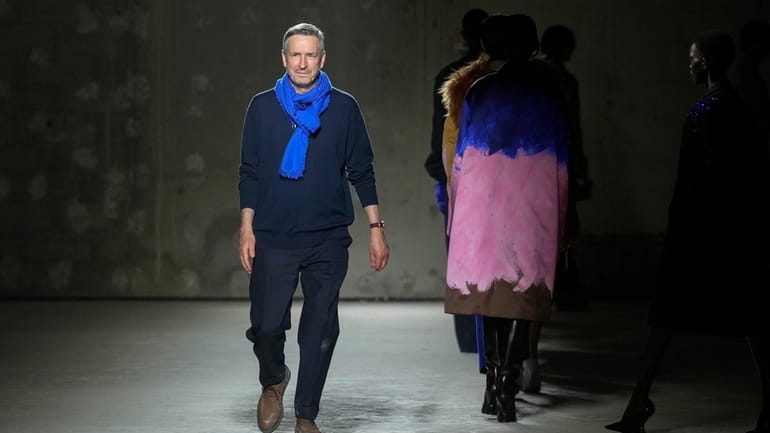 Belgian fashion designer Dries Van Noten accepts applause after his...