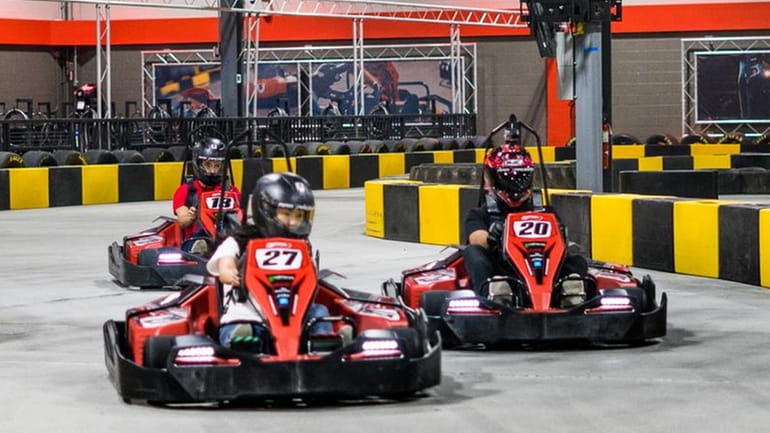 Families can race each other at the indoor go-kart track...