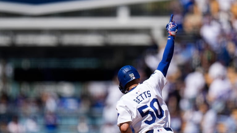 Los Angeles Dodgers' Mookie Betts celebrates his home run against...