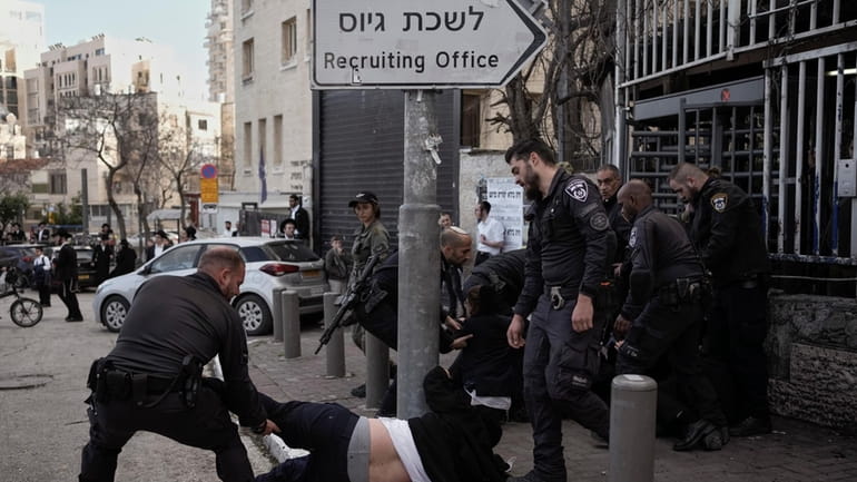 Israeli police officers scuffle with ultra-Orthodox Jewish men during a...