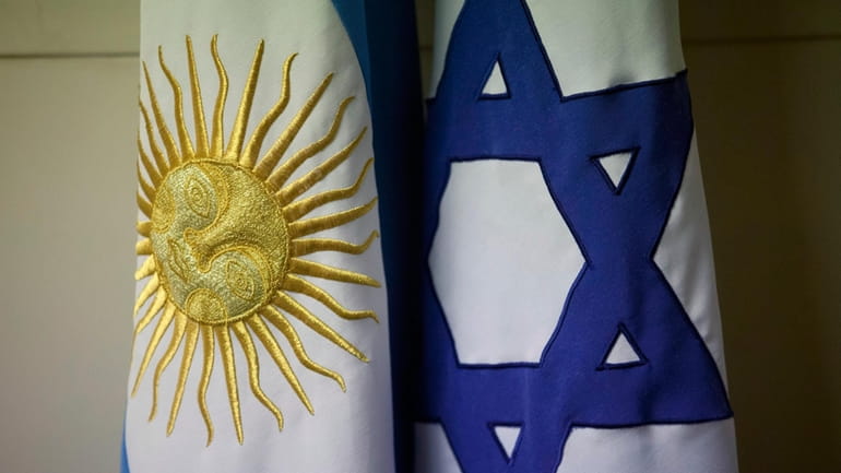 An Argentine and Israeli flag stand side by side at...