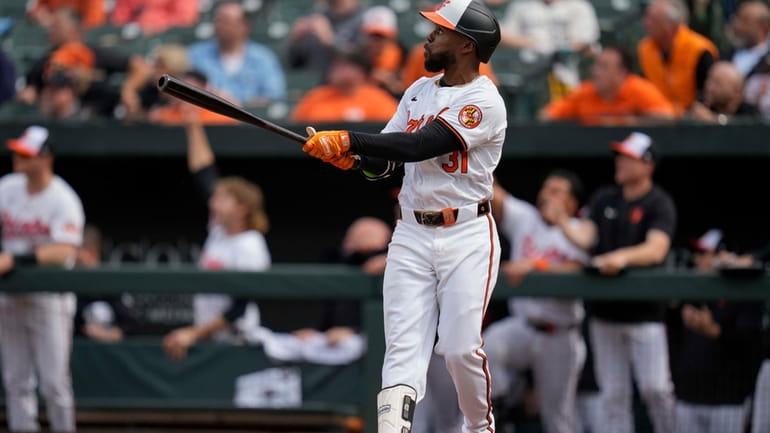 Baltimore Orioles' Cedric Mullins watches the ball after hitting a...