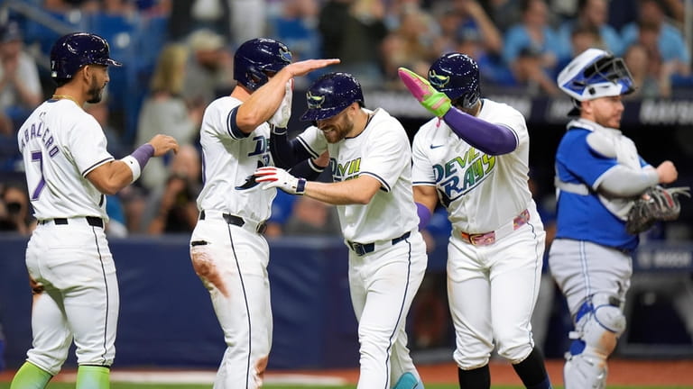 Tampa Bay Rays' Brandon Lowe, center, celebrates with teammates after...