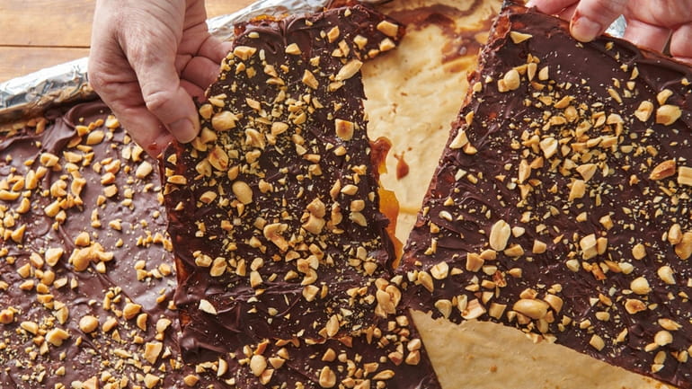 This photo shows chocolate toffee covered matzoh. Chocolate-covered caramel matzo,...