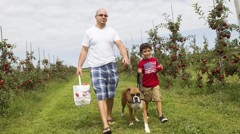 Ely Almonte from Mastic, his son Matthew, and their dog, Jada,...