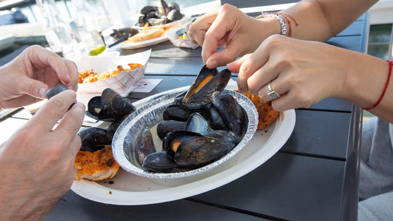 Diners share mussles at Point Lookout Clam Bar in Point...