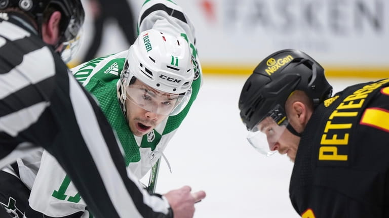 Dallas Stars' Logan Stankoven, left, lines up for a faceoff...