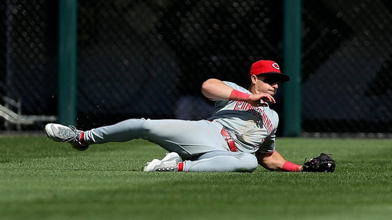 Cincinnati Reds' Spencer Steer makes a catch for an out...
