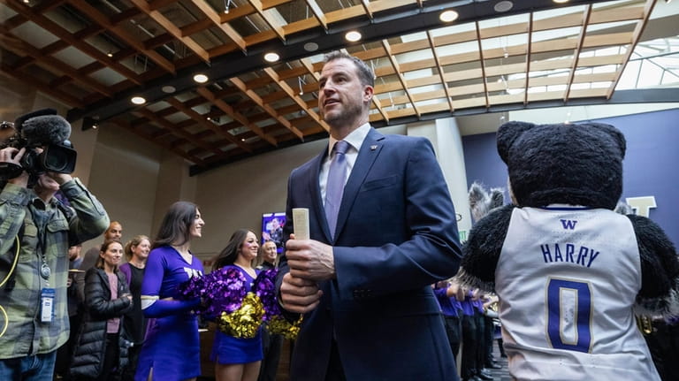 University of Washington's new men's basketball coach Danny Sprinkle arrives...