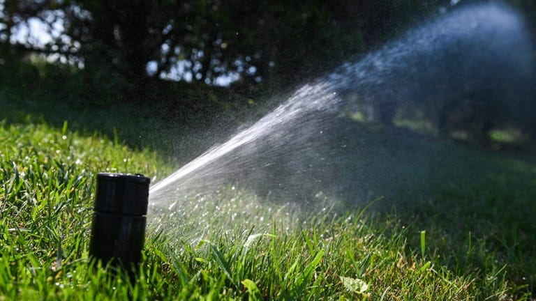 Sprinkler action in Suffolk County, where water authority officials have...