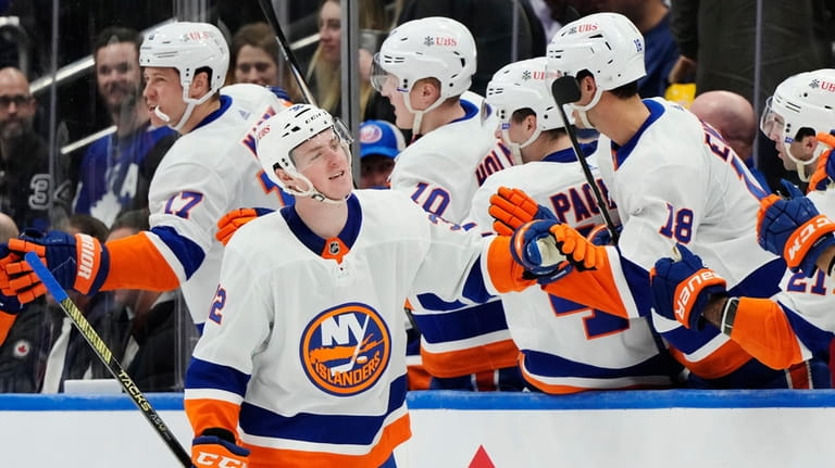 New York Islanders' Kyle MacLean, front, celebrates his goal on...