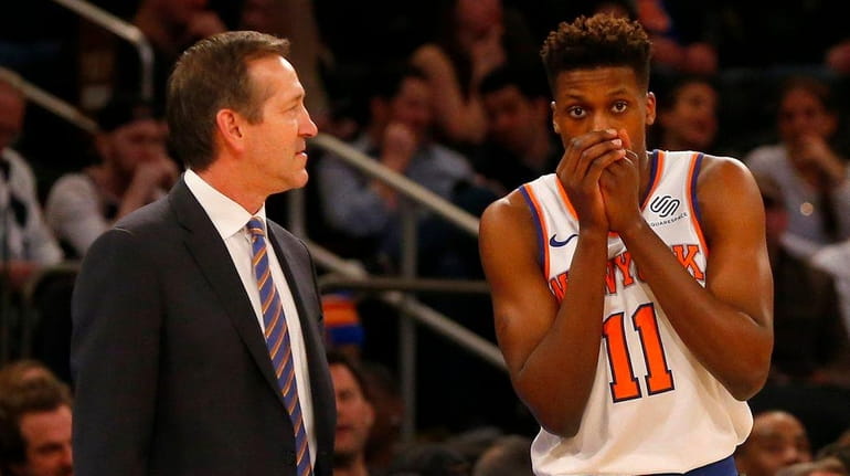 Knicks head coach Jeff Hornacek talks with Frank Ntilikina during...