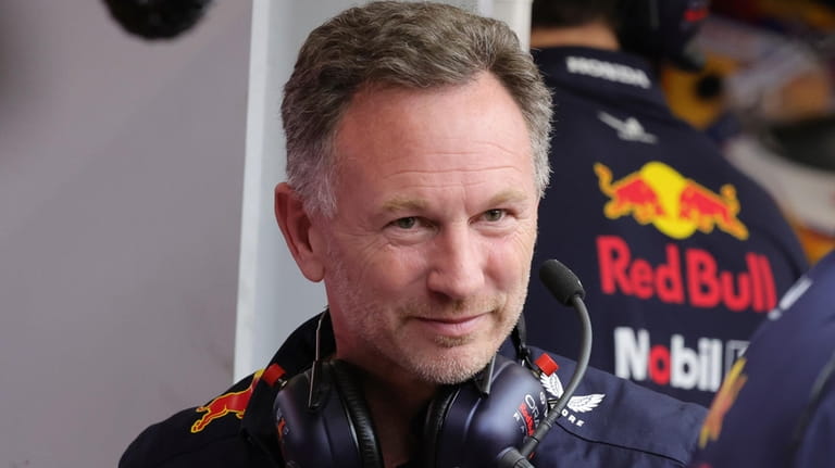 Red Bull team principal Christian Horner watches at pits during...