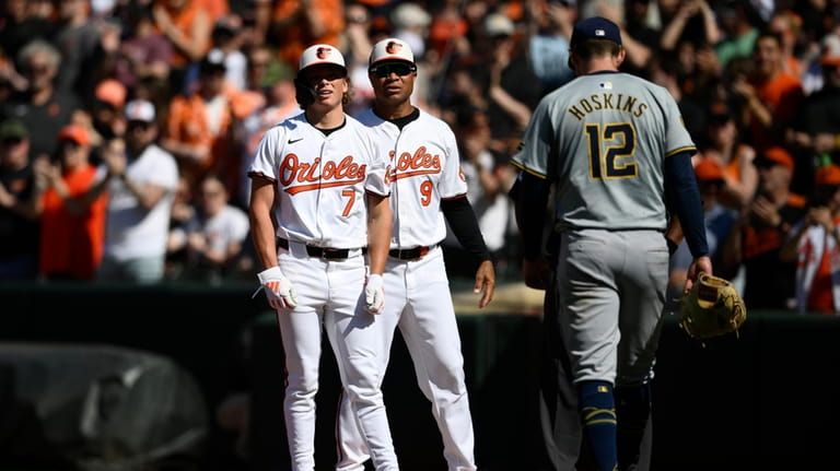 Baltimore Orioles' Jackson Holliday (7) stands at first next to...