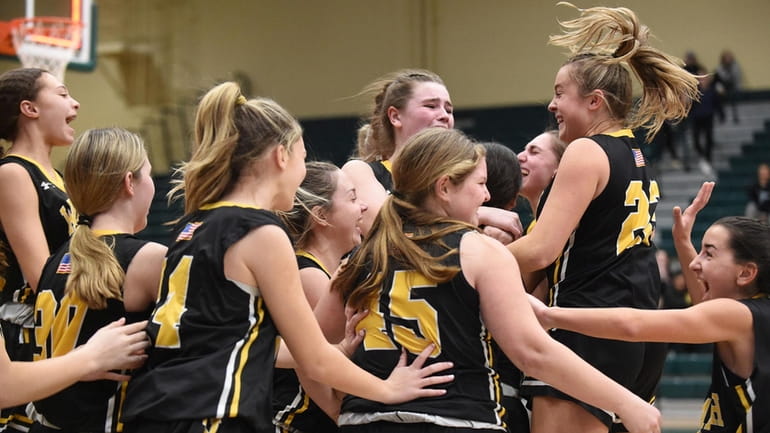 Wantagh teammates celebrate after their 37-28 win over Lynbrook in...