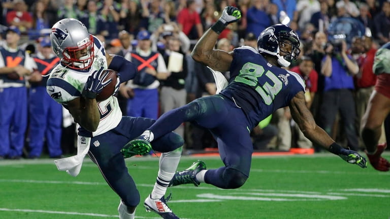 Patriots cornerback Malcolm Butler intercepts a pass intended for Seahawks...