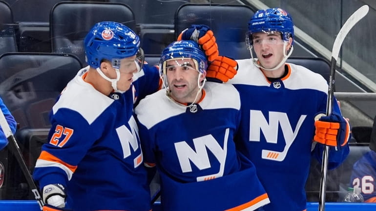 The Islanders' Kyle Palmieri, center, celebrates with Anders Lee, left,...