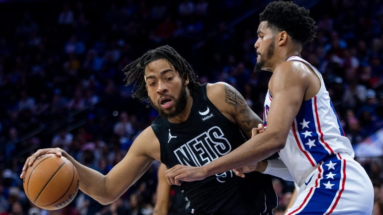 The Nets' Trendon Watford, left, tries to get to the...
