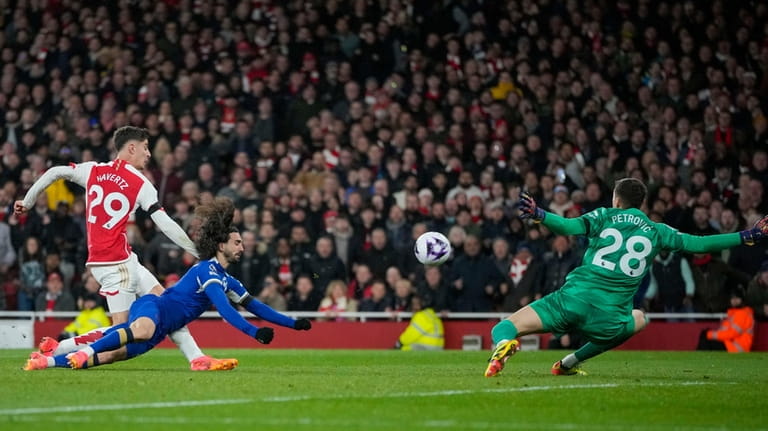 Arsenal's Kai Havertz, left, scores his side's third goal during...