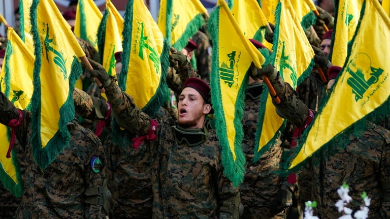 Hezbollah fighters attend the funeral of their commander Wissam al-Tawil,...
