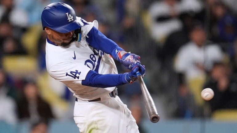 Los Angeles Dodgers' Mookie Betts connects for a single against...