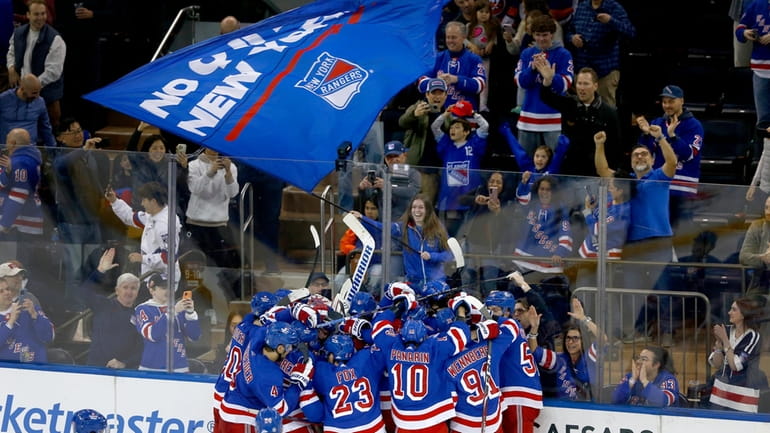 The New York Rangers and fans celebrate a shootout victory...
