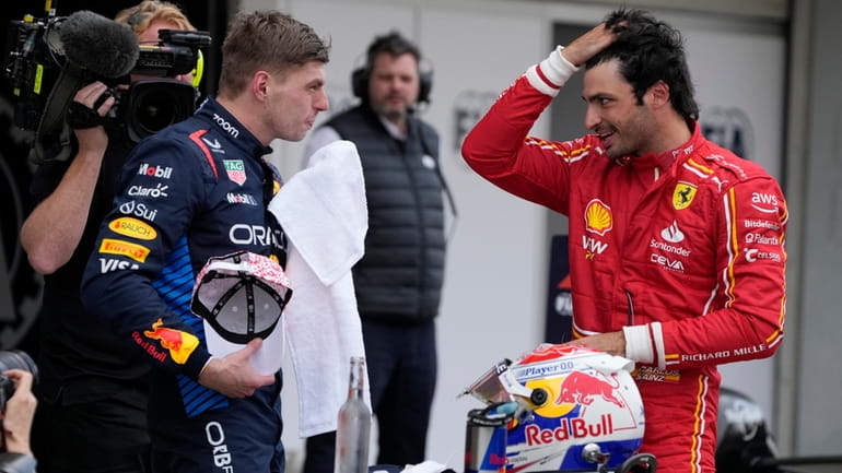 Red Bull driver Max Verstappen of the Netherlands, left, Ferrari...