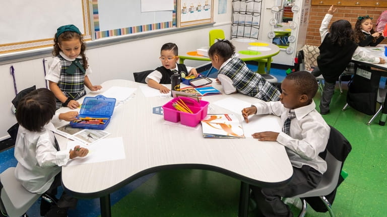 Kindergartners get to work in a charter school class co-taught...