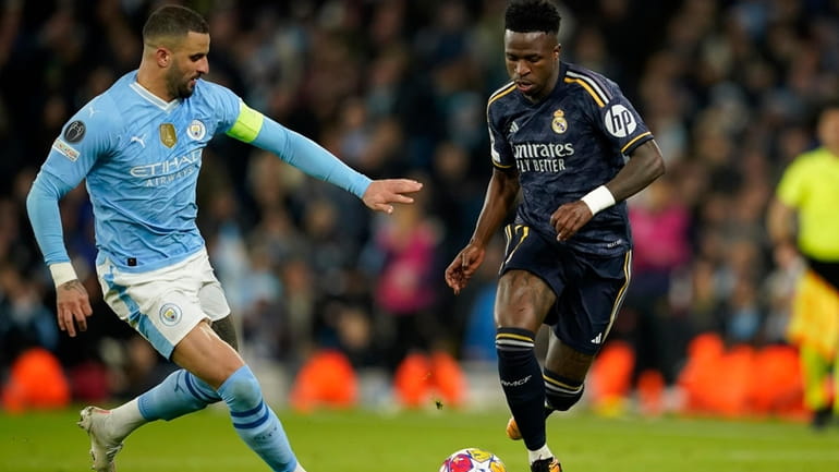 Manchester City's Kyle Walker fights for the ball with Real...