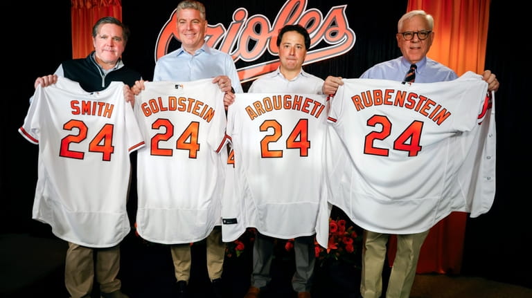Baltimore Orioles majority owner David Rubenstein, right, poses for photos...