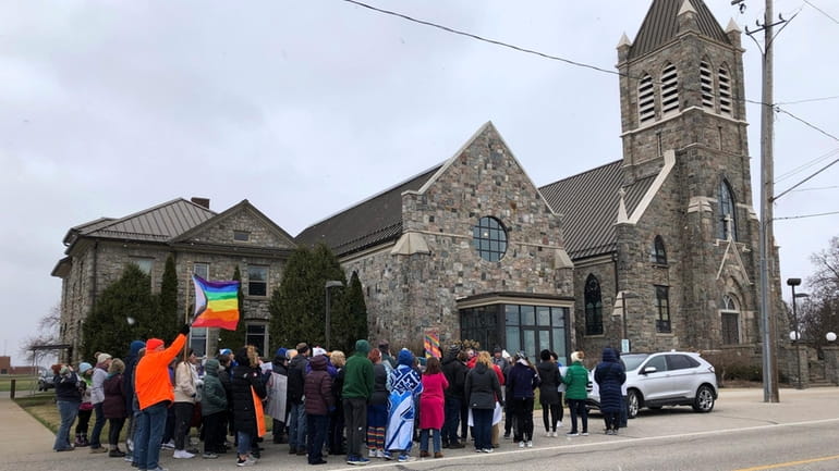Protesters gather outside St. Joseph the Worker Church on March...