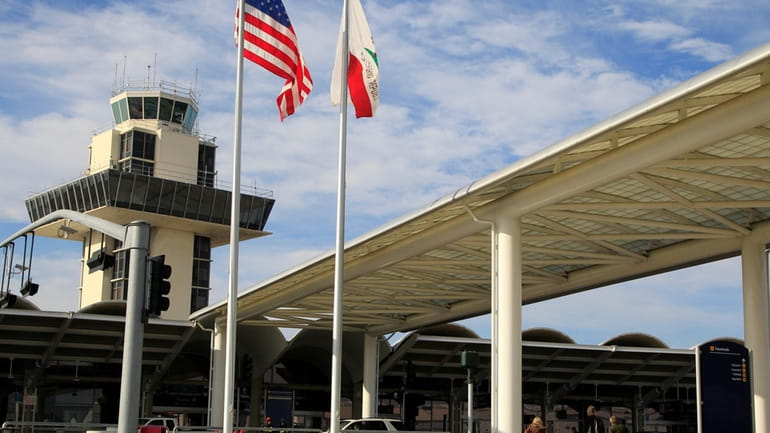 Travelers prepare to enter Oakland International airport Tuesday, Nov. 26,...