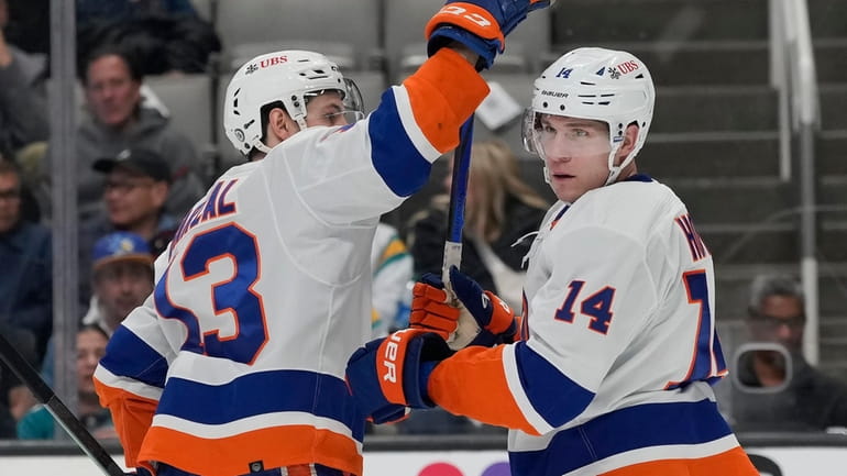 Islanders center Bo Horvat, right, is congratulated by center Mathew...