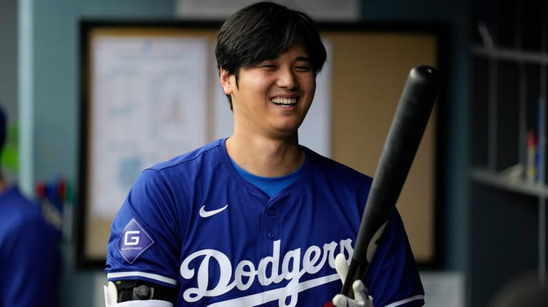 Los Angeles Dodgers designated hitter Shohei Ohtani (17) prepares his...