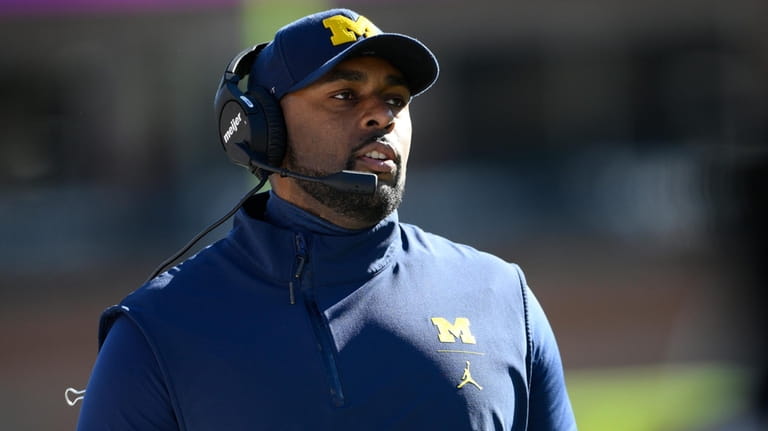 Michigan acting coach Sherrone Moore watches play during the first...