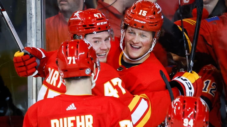 Calgary Flames forward Connor Zary (47) celebrates his goal with...