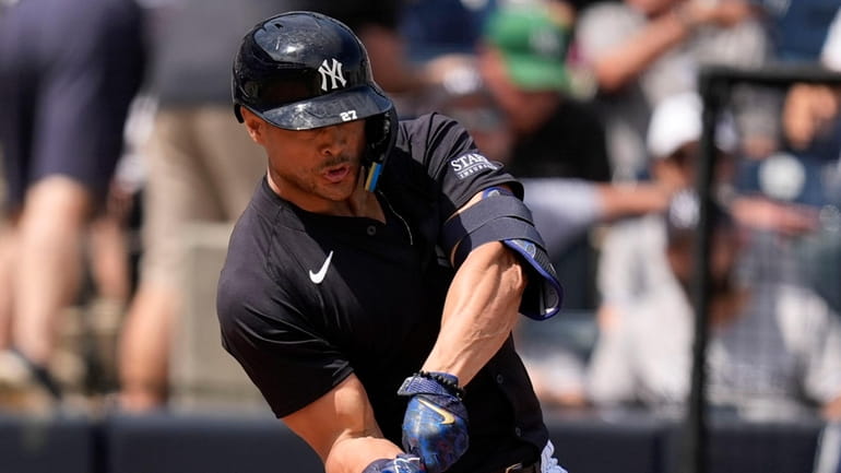 The Yankees' Giancarlo Stanton hits a single in the fourth...