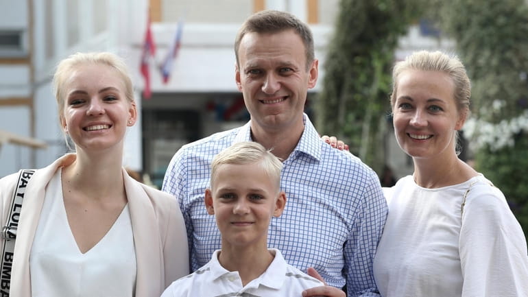 Russian opposition leader Alexei Navalny, with his wife Yulia, right,...