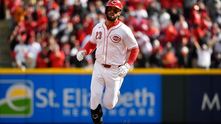 Cincinnati Reds' Nick Martini (23) rounds the bases after hitting...