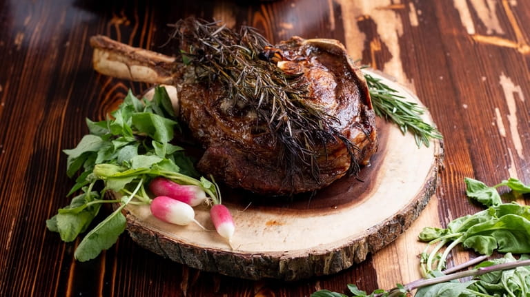 A dry-aged tomahawk ribeye steak with roasted rosemary at Off...