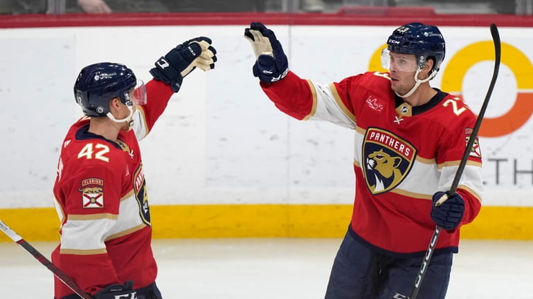 Florida Panthers center Carter Verhaeghe (23) is congratulated by defenseman...
