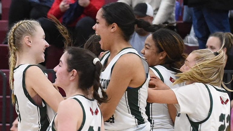 Kate Sweet #13 of Westhampton, left, and teammates celebrate after...