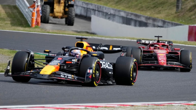 Red Bull driver Max Verstappen of the Netherlands, left, leads...