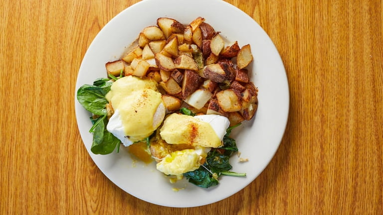 Crab benedict served with roasted potatoes at Country Cottage Diner...